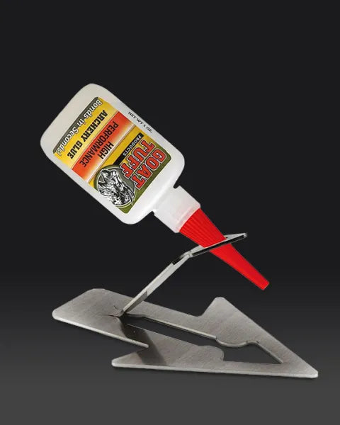Goat Tuff Adhesive archery glue shown on stand to keep adhesive ready for fletching arrows.